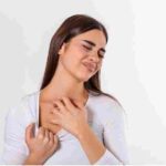 young woman scratching her neck due itching gray background female has itching neck concept allergy symptoms healthcare 11zon