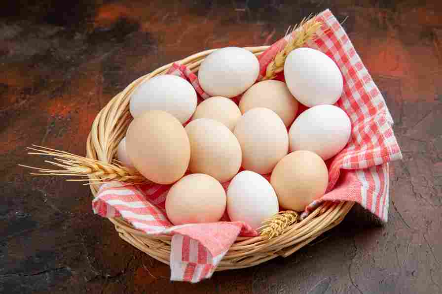 front view white chicken eggs inside basket with towel dark surface 11zon