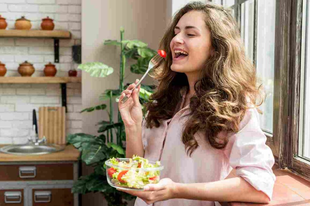 brunette woman eating salad 11zon