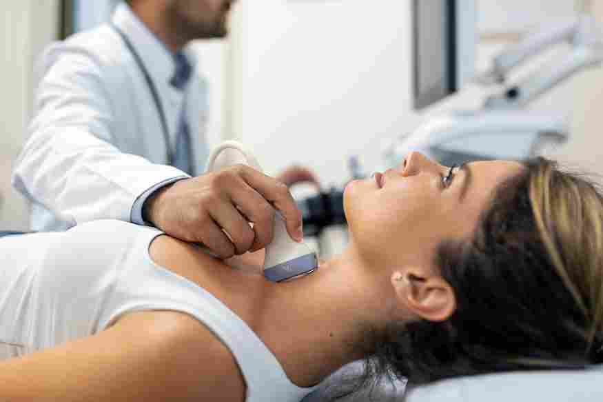 close up shot young woman getting her neck examined by doctor using ultrasound scanner modern clinic 11zon