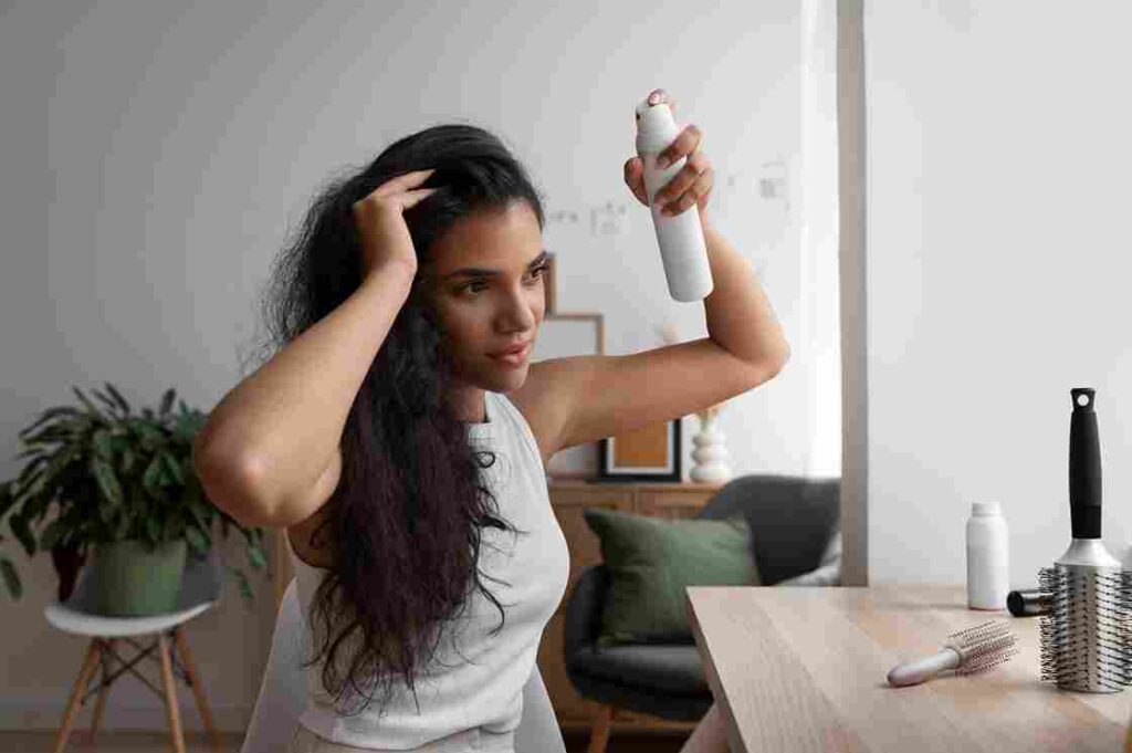 medium shot woman using dry shampoo home 11zon