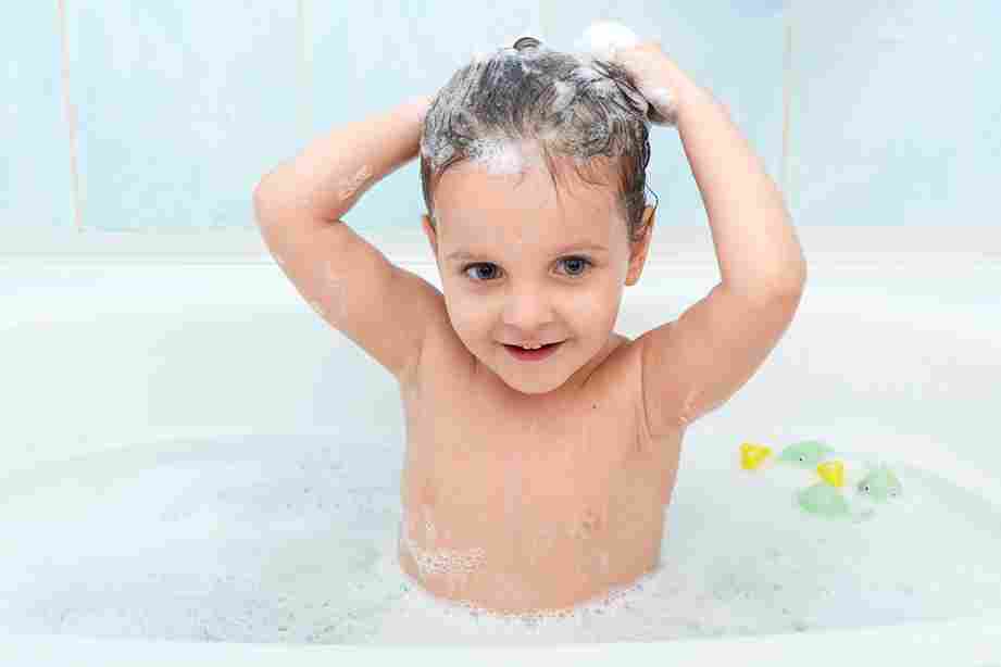 little cute girl taking bath washing her hair with shampoo by herself 11zon